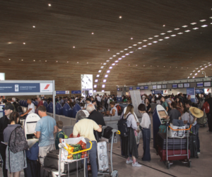 people at the airport lining up for check in
