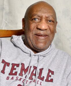 Bill Cosby wearing white hoodie while smiling