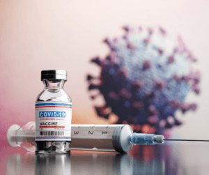 covid 19 vaccine besides image of a virus