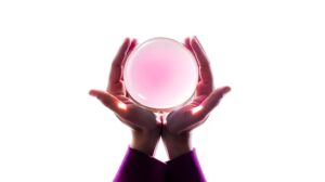 Two hands with sleeves are cupped together, holding a large, translucent pink sphere that glows softly against a bright white background