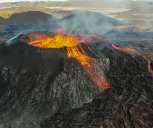 an erupting volcano with magma flowing out of its mouth