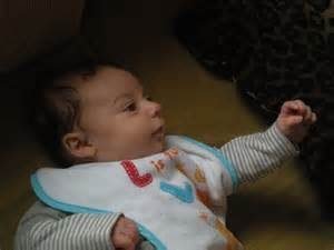 A baby reaching up to something others can't see may be seeing an angel. [Image credit: Michael Coghlan via Flickr)