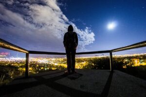 man looking at blue sky clouds