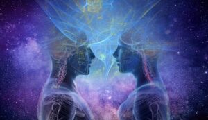 An ethereal image depicting two translucent human figures, showing skeletal and neurological structures, facing each other with swirling, luminous energy connecting their heads