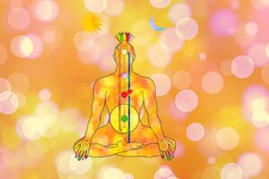 Stylized illustration of a meditating figure with chakra points aligned