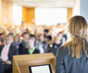 People listening to a speaker at conference