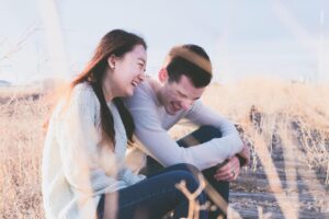 a couple sharing a joyful moment and laughing together outdoors