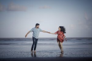 couple walking by the beach