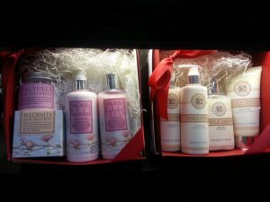 Two gift sets of bath and body products, including lotions, shower creams, and hair treatments
