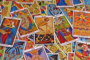 a vibrant, close-up, overhead shot of a collection of scattered Tarot cards
