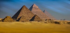the ancient Pyramids of Giza rising majestically from the golden desert sands