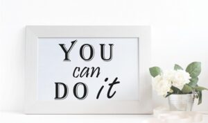 a white framed picture on a white surface, featuring the motivational phrase "YOU can DO it"