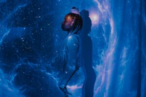 woman standing on galaxy like background