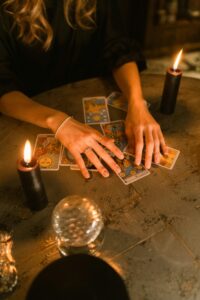 hands touching tarot cards