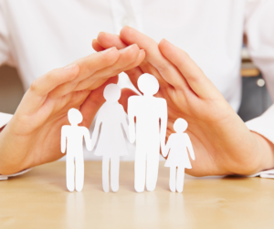 hands protecting family figures