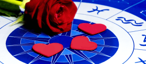 red rose and three heart shapes on top of astrological chart