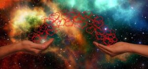 Two hands reaching for each other, connected by an arc of glowing red hearts, against a cosmic background of a nebula and stars.